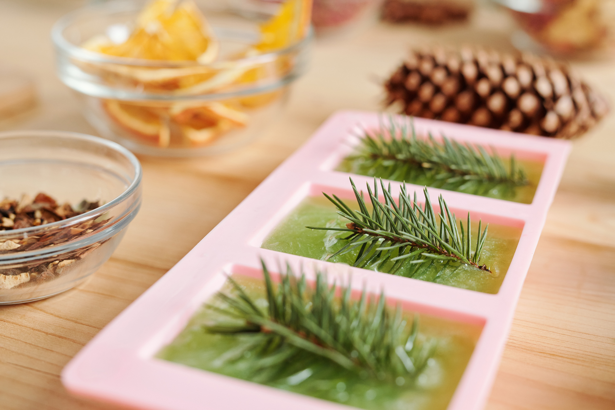 Handmade green soap with conifer and glassware with aromatic ingredients